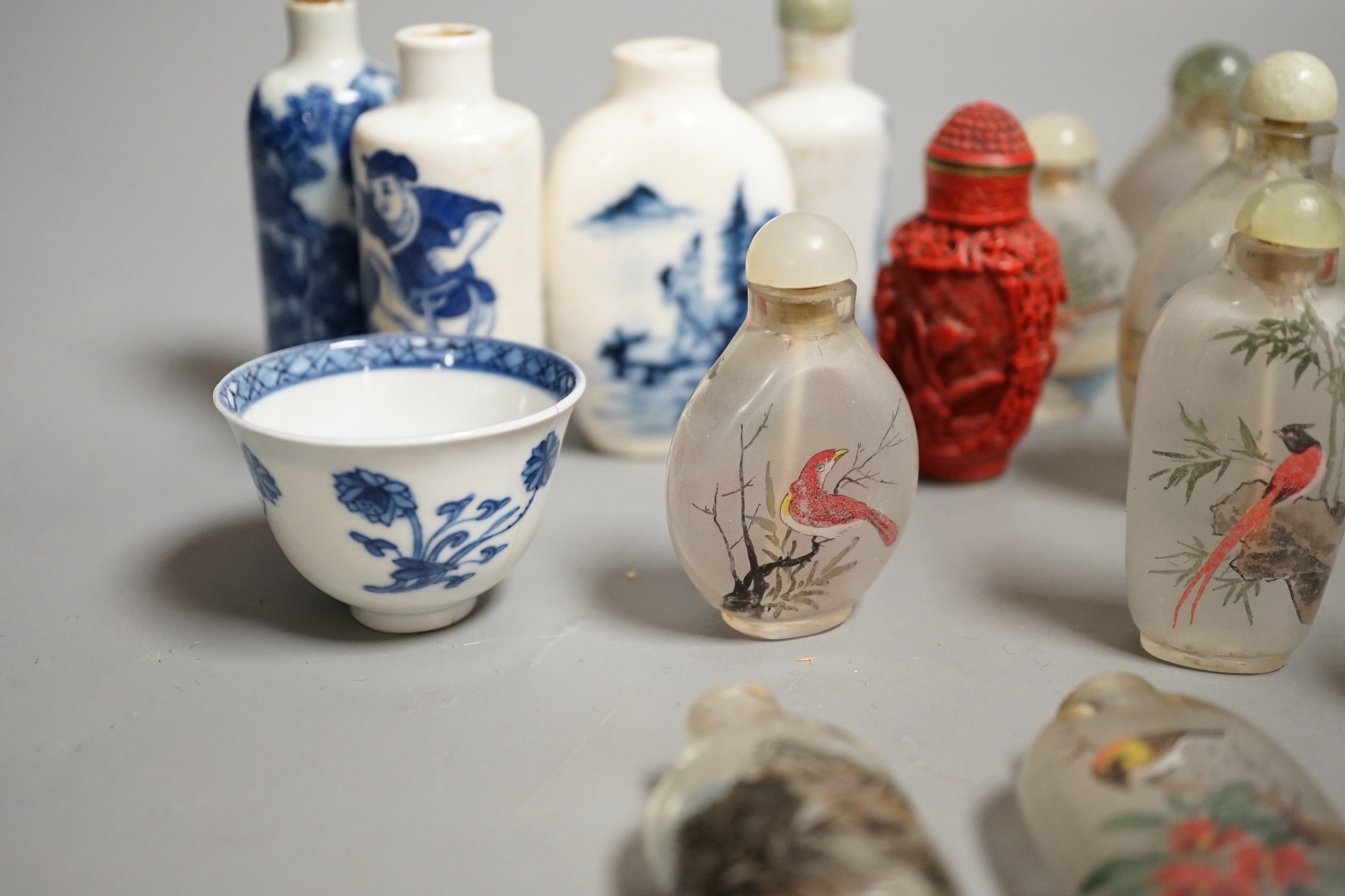 A collection of 20th century Chinese export reverse painted snuff bottles with associated blue and white porcelain examples, some 19th century